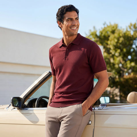 A man wearing the Legacy Resort Polo in Maroon, lifestyle setting.