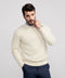 A man wearing the Anytime Crewneck Sweater in Cream