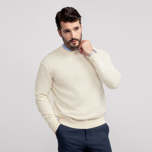 A man wearing the Anytime Crewneck Sweater in Cream