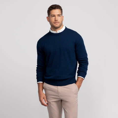 A man wearing the Anytime Crewneck Sweater in Deep Blue