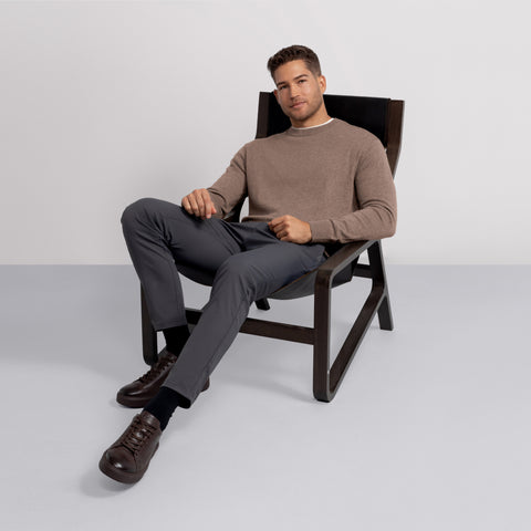 Man in the Anytime Crewneck Sweater Mocha Heather in a lifestyle shot