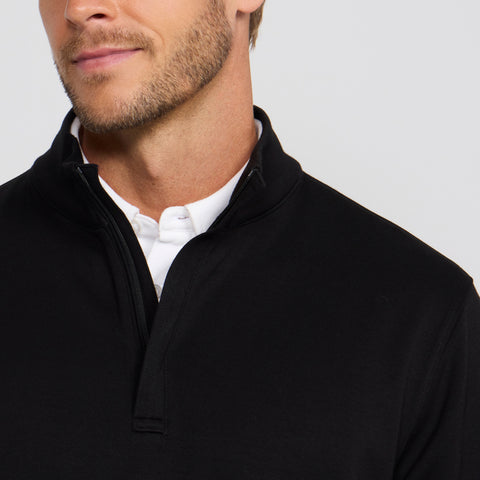 A man in the Sandwash Quarter-Zip True Black in a professional setting