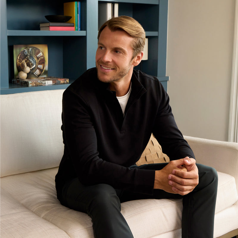 Man wearing the Sandwash Quarter-Zip True Black in a lifestyle scene