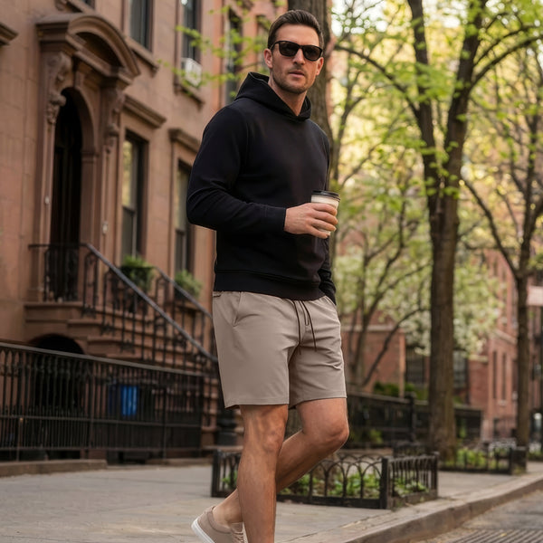 A man wearing the Atlas Short in Desert Taupe, outdoor setting