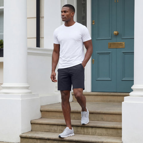 A man wearing the Atlas Short 8 inch in Navy Blue in a lifestyle setting