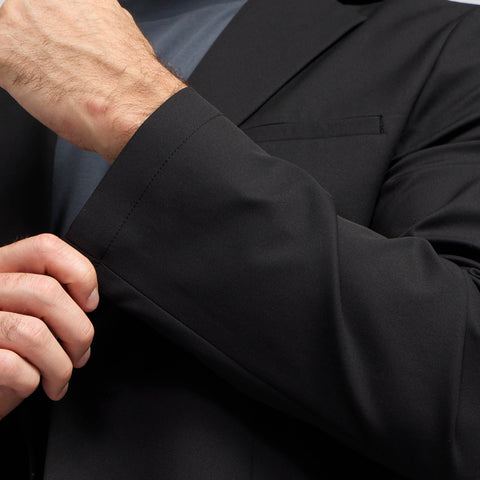 A man in the Jetsetter Blazer True Black in a professional setting