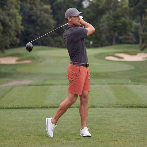 A man wearing the Clubhouse Pique Polo in Charcoal Gray