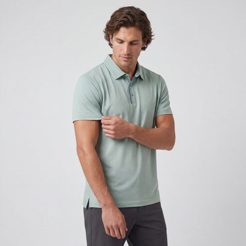 Man wearing a light green polo shirt on a white background
