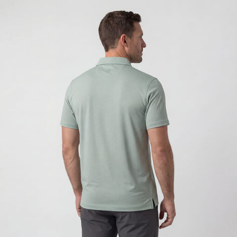Man wearing a light green polo shirt on a white background