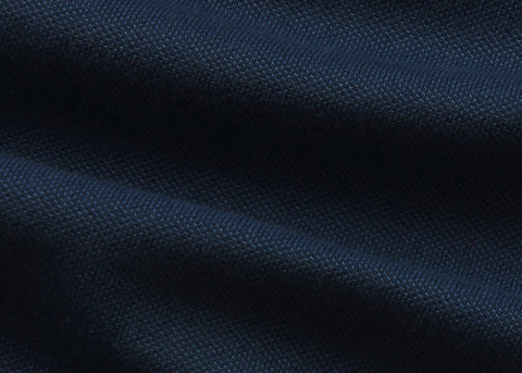 The Clubhouse Pique Polo in Tidal Blue on a neutral background