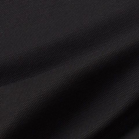 Close-up of Jack Archer’s Clubhouse Pique Polo in True Black, featuring a fine, tightly woven texture with gentle folds—showcasing subtle shadows, highlights, and advanced moisture management.