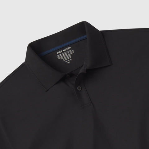 A neatly folded Clubhouse Pique Polo in True Black by Jack Archer, with a collar, two buttons, and a visible inner Jack Archer label on a light background.