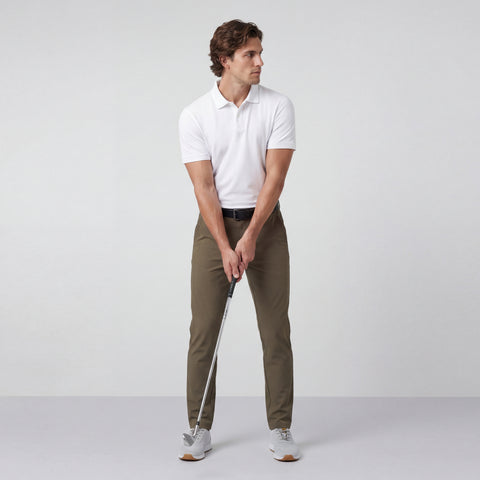 A man wearing the Clubhouse Pique Polo in True White.