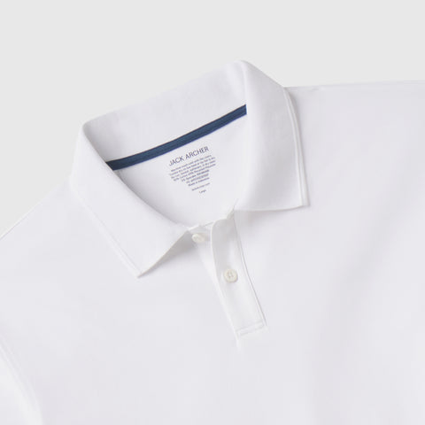 The Clubhouse Pique Polo in True White, worn in lifestyle setting.
