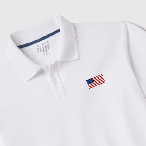 The Clubhouse Pique Polo USA Flag in True White, lifestyle detail.