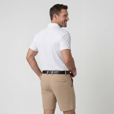 A man wearing the Clubhouse Performance Polo in White Driveline from behind.