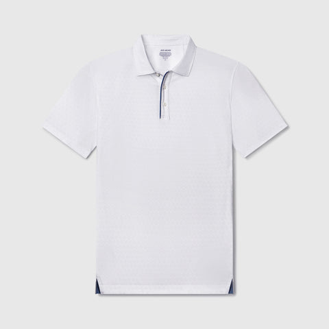 A man wearing the Clubhouse Performance Polo in White Driveline outdoors.