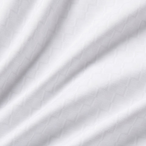 The Clubhouse Performance Polo in White Driveline, flat lay.