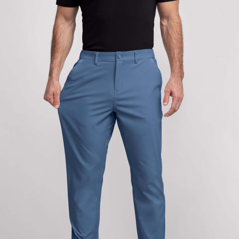 A man in the Jetsetter Tech Pant Relaxed Fit in Bering Sea in a lifestyle setting