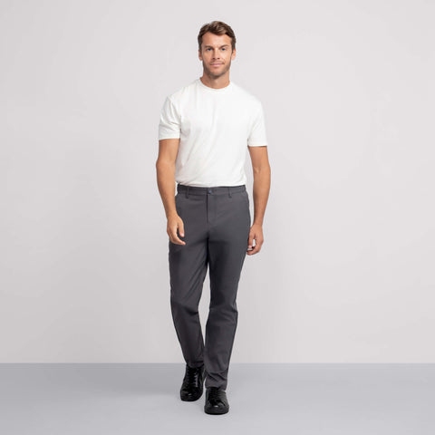 A man wearing the Jetsetter Tech Pant Relaxed Fit in Charcoal Gray.