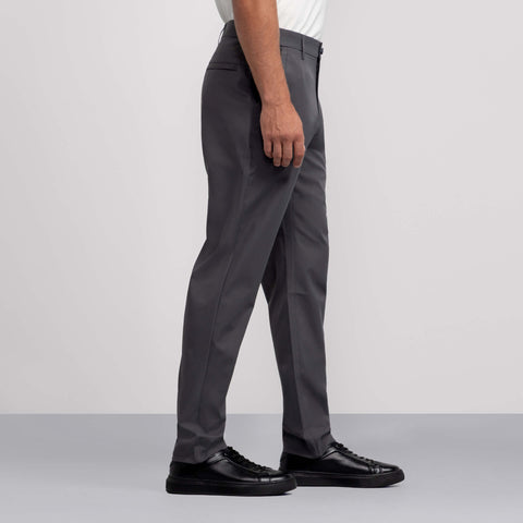 A man wearing the Jetsetter Tech Pant Relaxed Fit Charcoal Gray from the side.