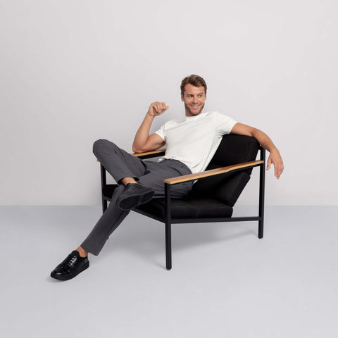 A man in the Jetsetter Tech Pant Relaxed Fit Charcoal Gray in motion.