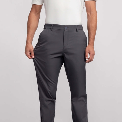 A man in the Jetsetter Tech Pant Relaxed Fit Charcoal Gray, lifestyle shot.