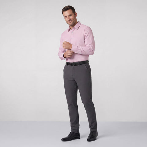 Charcoal Jetsetter pants worn with a pink button-down shirt and black derby shoes, shown full length.