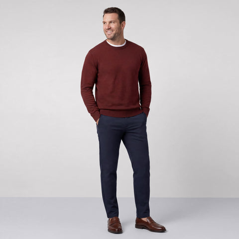 Navy Jetsetter pants worn with a burgundy crewneck sweater and brown loafers, shown full length.