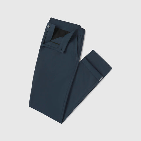 The Jetsetter Tech Pant Slim Fit in Deep Teal, folded on white background.