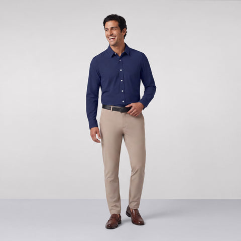 Khaki Jetsetter pants worn with a navy button-down shirt and brown loafers, shown full length.