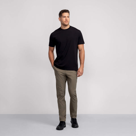 A man wearing the Jetsetter Tech Pant Classic Fit in Olive Green