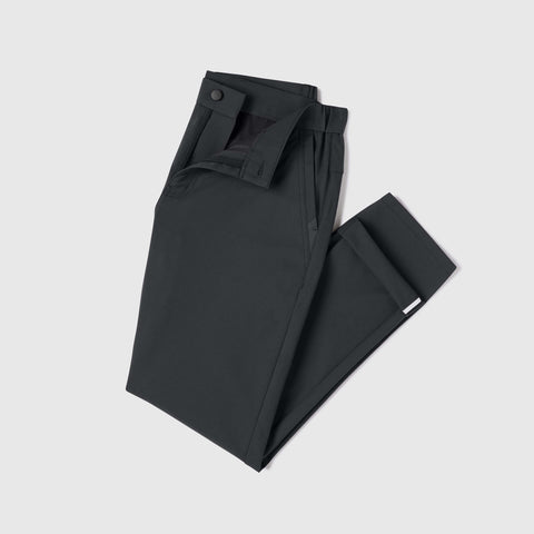 The Jetsetter Tech Pant Slim Fit in Space Black, folded on white background.