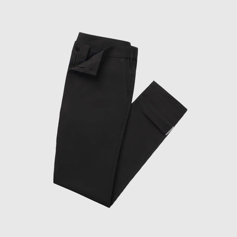 The Jack Archer Jetsetter Tech Pant Relaxed Fit in True Black, featuring a waistband closure, is neatly folded and displayed on a plain white background.