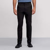 A person, shown from the waist down against a light background, wears Jack Archer’s Jetsetter Tech Pant 3-Pack in black along with black sneakers and a blue shirt.
