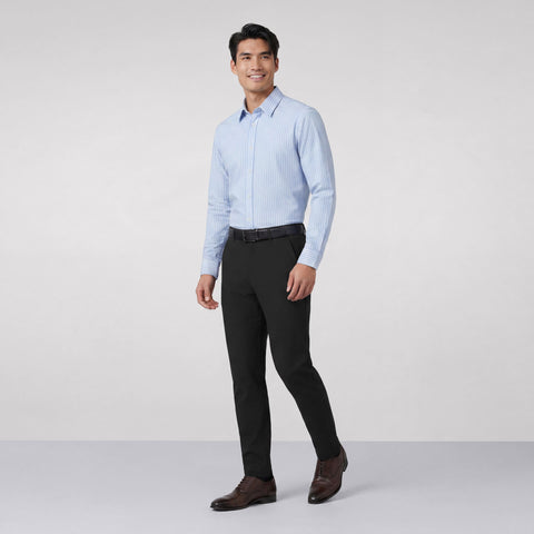 Black Jetsetter pants worn with a light blue striped shirt and brown dress shoes, shown full length.