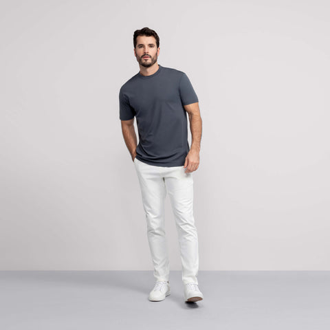 A man wearing the Jetsetter Tech Pant Slim Fit in True White