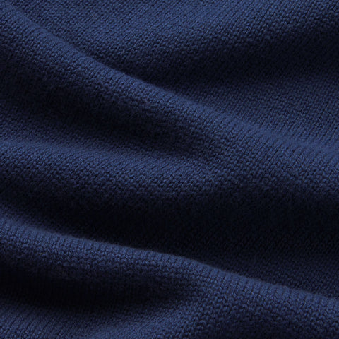 A man wearing the Jetsetter Quarter-Zip Sweater in Navy