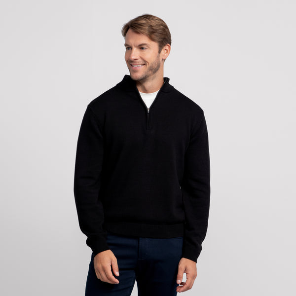 A man wearing the Jetsetter Quarter-Zip Sweater in True Black