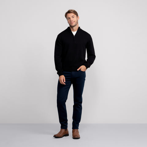 A man wearing the Jetsetter Quarter-Zip Sweater in True Black.