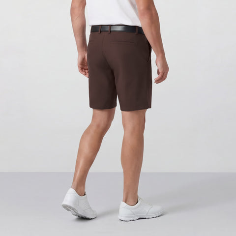 A man sitting wearing the Jetsetter Tech Short 7 inches in Bourbon Brown