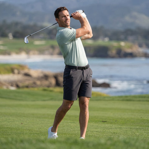 A man wearing the Jetsetter Tech Short 7 in Charcoal Gray while sitting.
