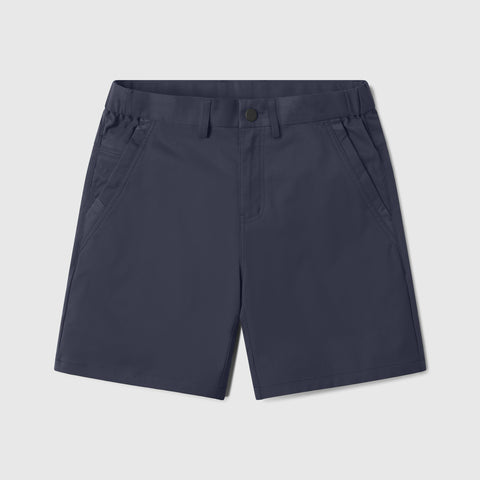 A man wearing the Jetsetter Tech Short 7" in Deep Blue outdoors
