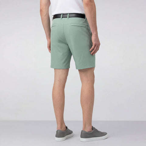 A man wearing the Jetsetter Tech Short 7 inch in Sage Green outdoors.
