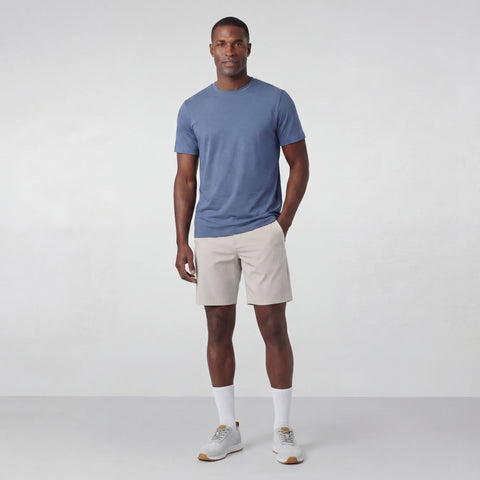 A man wearing the Jetsetter Tech Short 7" in Sand Stone
