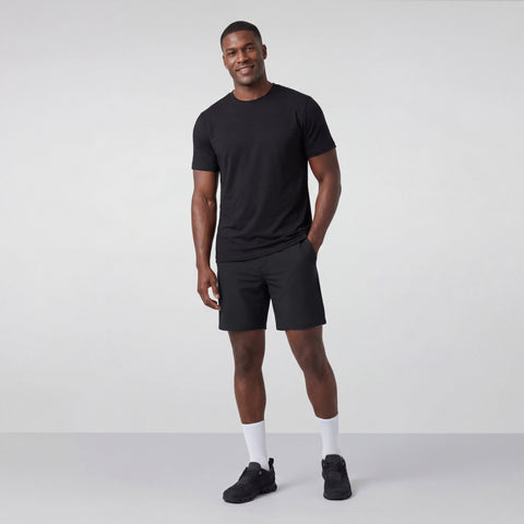 A man wearing the Jetsetter Tech Short 7" in Space Black, side view.
