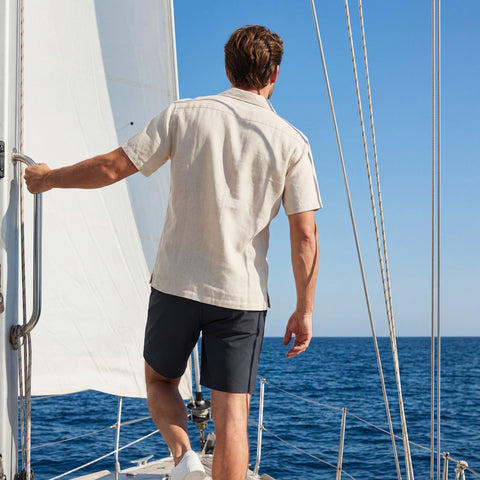 A man wearing the Jetsetter Tech Short 7" in Space Black, active lifestyle shot.