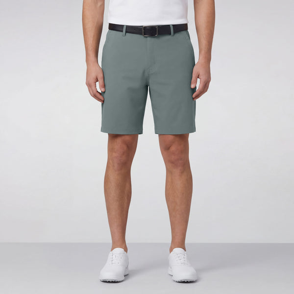 A man wearing the Jetsetter Tech Short 7 inches in Storm Green