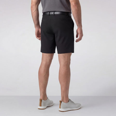 A man sitting wearing the Jetsetter Tech Short 7 inches in True Black