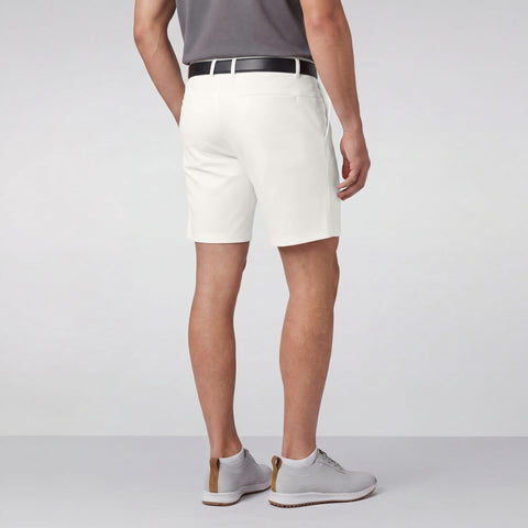 A man wearing the Jetsetter Tech Short 7 inch in True White outdoors.